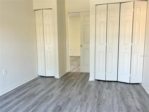 3rd bedroom or office area off living room with extra closet space