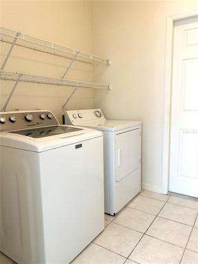 Laundry room with washer and dryer which convey
