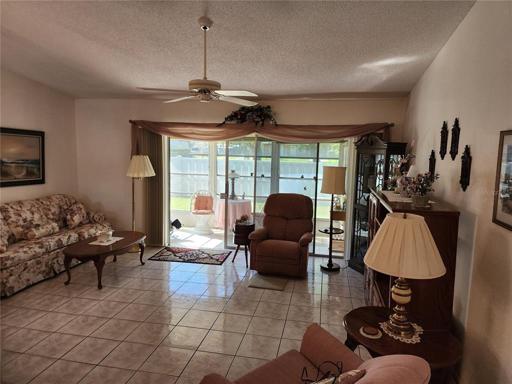 Open Living Room w/view into Glassed in Lanai
