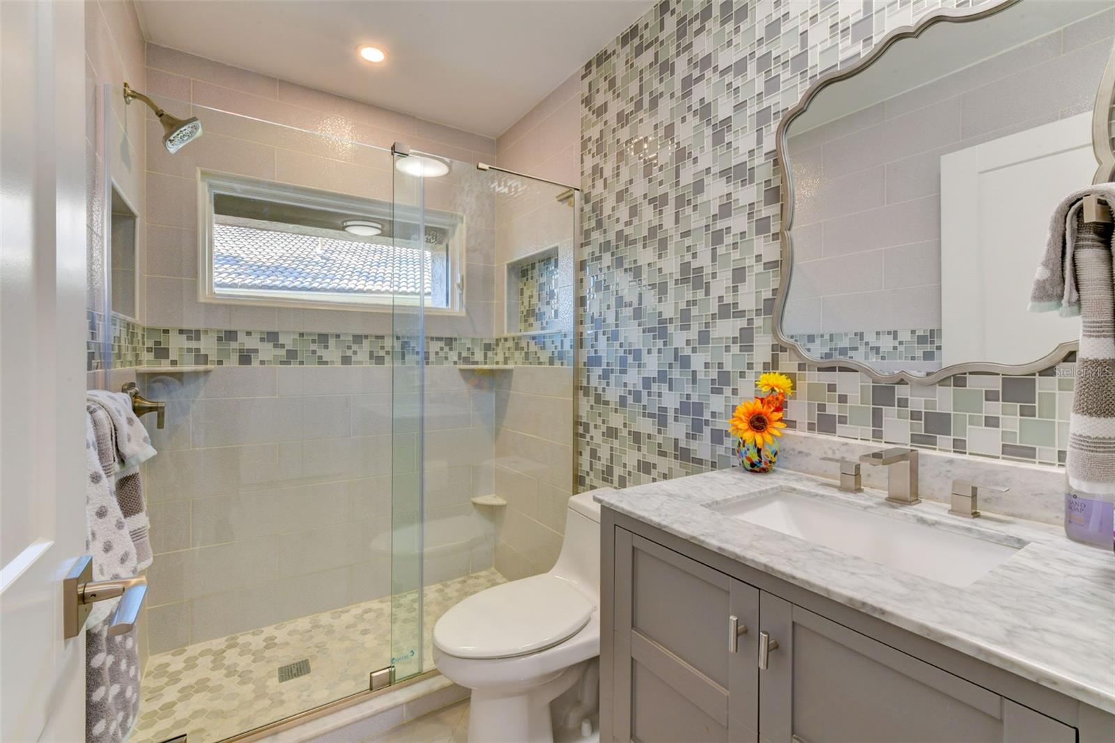Guest bathroom with walk-in shower and adorable backsplash