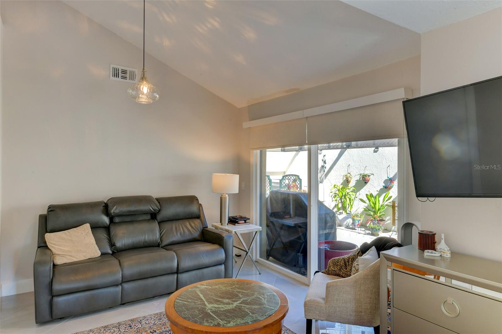 Glass sliding doors to the side porch from the main bedroom