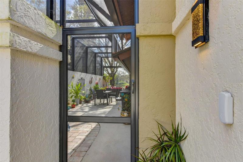 Enter into the side porch.  It was screened in 2022.