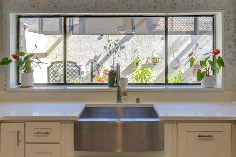 Wide window frames the kitchen