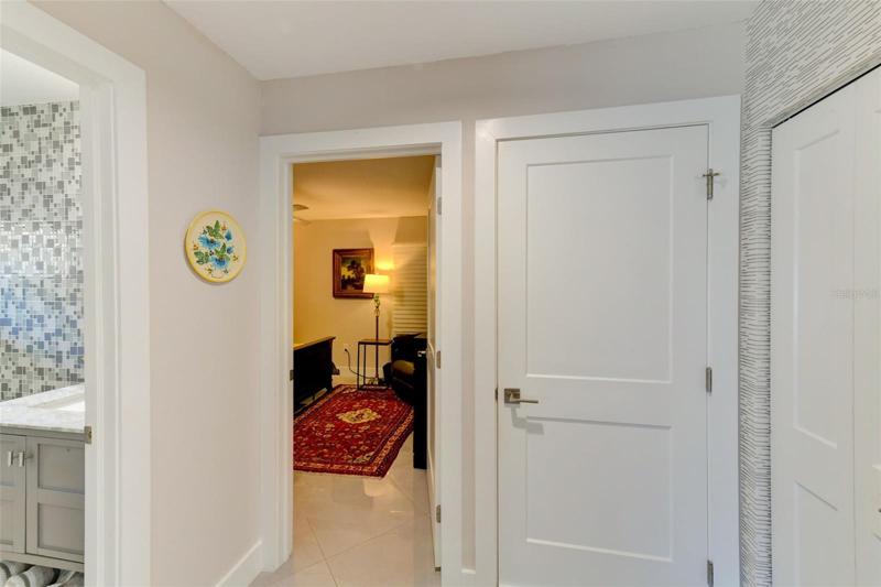 View of the guest bathroom, the third bedroom and the laundry room