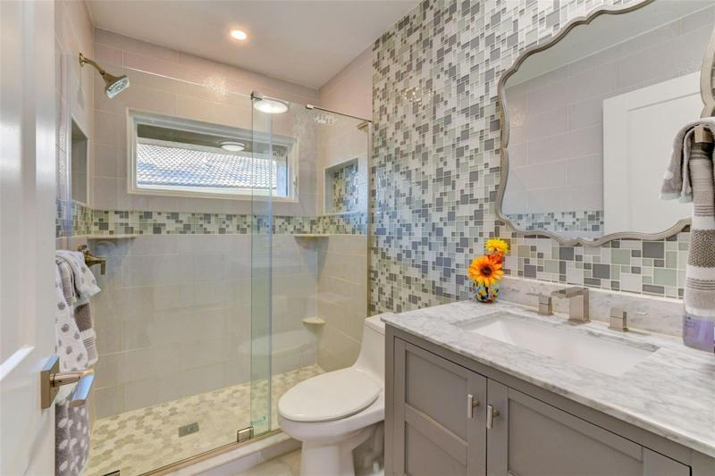 Guest bathroom with walk-in shower and adorable backsplash