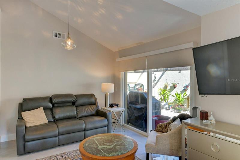 Glass sliding doors to the side porch from the main bedroom