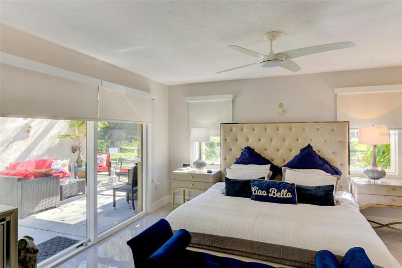 Glass sliding doors from the main bedroom lead to the side screen porch