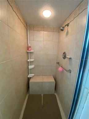 Master shower with convenient seat.