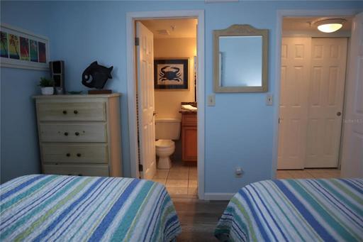 Another view of the guest bedroom with an entrance to the guest bathroom.