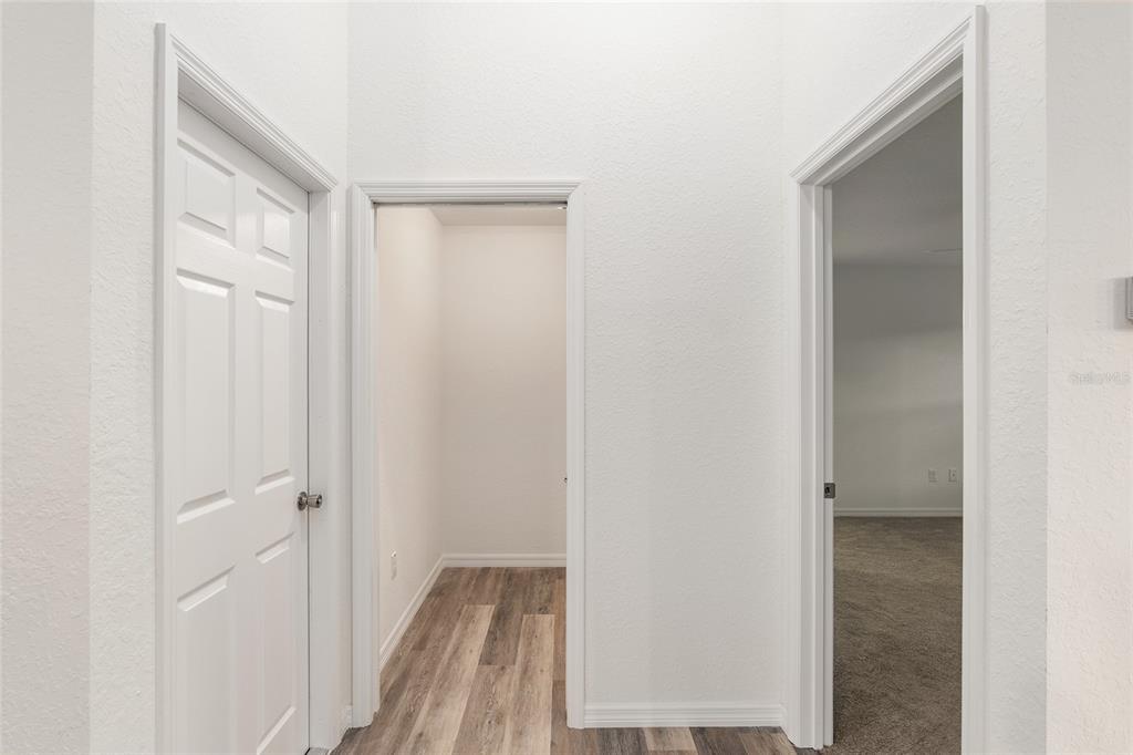 Hall to Garage on left, Laundry Room straight ahead and Master BR on the right