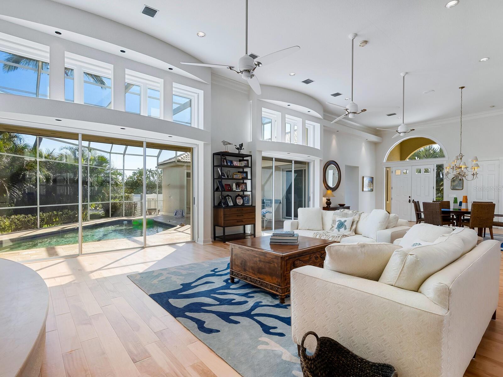 The walls of windows are so inviting to the outdoor pool &amp; patio