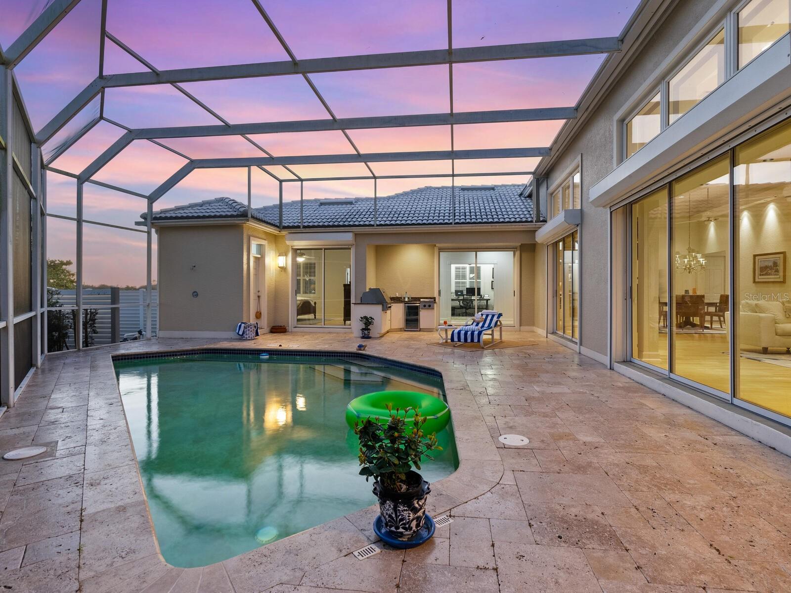 The entire home opens up to this spacious patio, summer kitchen pool area..