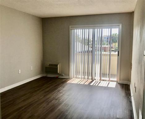 Spacious living space with sliders to private patio overlooking the pool.