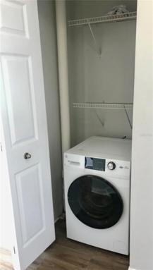 Combo washer dryer in laundry closet off kitchen.