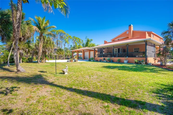 side yard completely fenced. Large screened enclosed porch complete with out door kitchen and gas fireplace. Driveway to oversized Garage /work shop large enough for all the toys including a motorhome, boat,cars,ect.