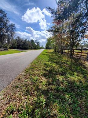 Front fence of property and road traveling south