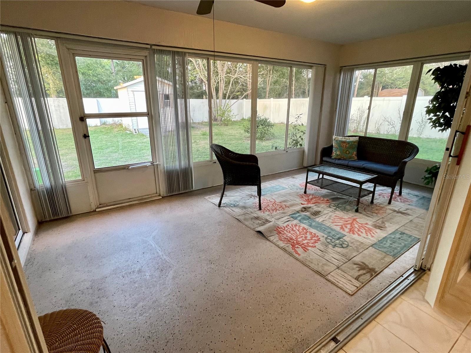 Closed in Florida room, windows and AC, painted concrete floors. The slider opens up and hides behind the wall