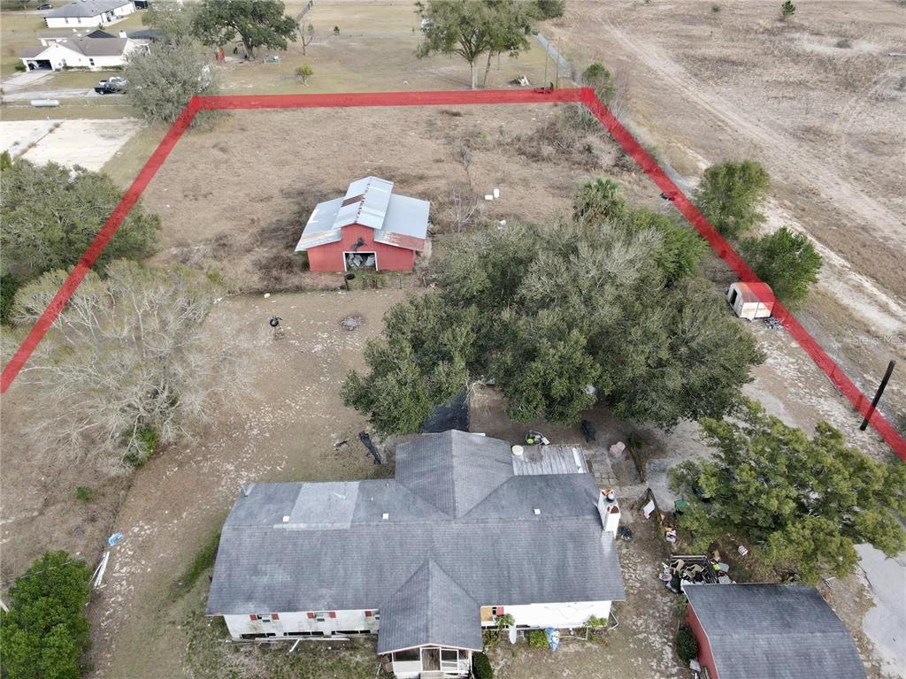 Overhead view of the existing building structures. Some of the property has fencing.