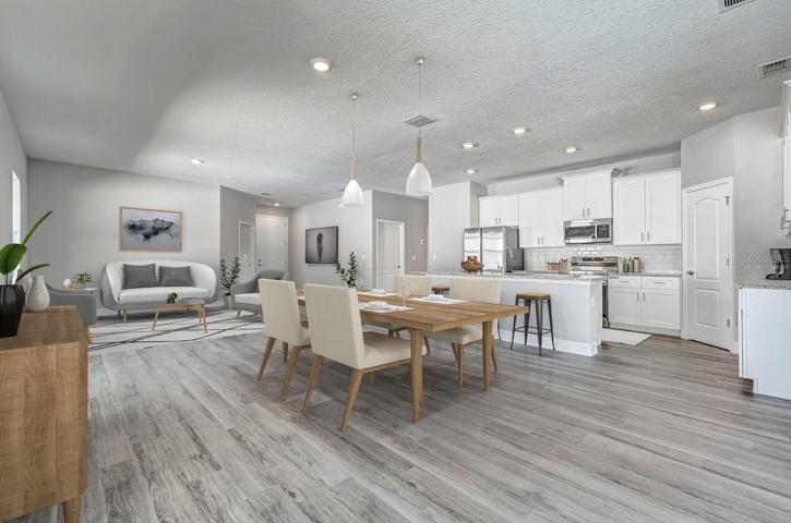 Virtually staged. Living room, dining room and open kitchen area.