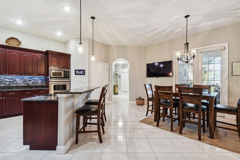 Kitchen is open and overlooks patio with french doors leading out