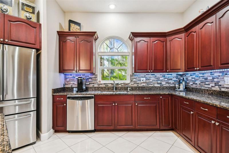 Designer backsplash and under counter lighting-extra tall cabinets for storage
