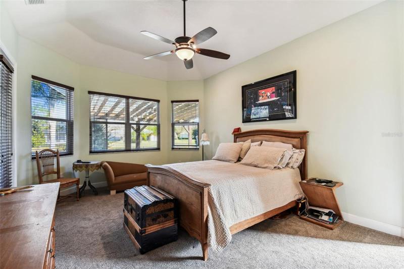 Owners suite overlooks backyard views and pond