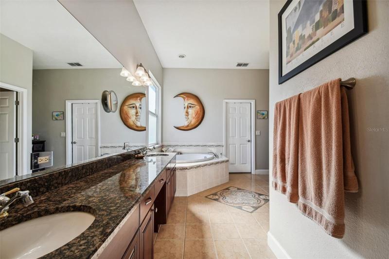 Double sinks and plenty of counter space in owners bath