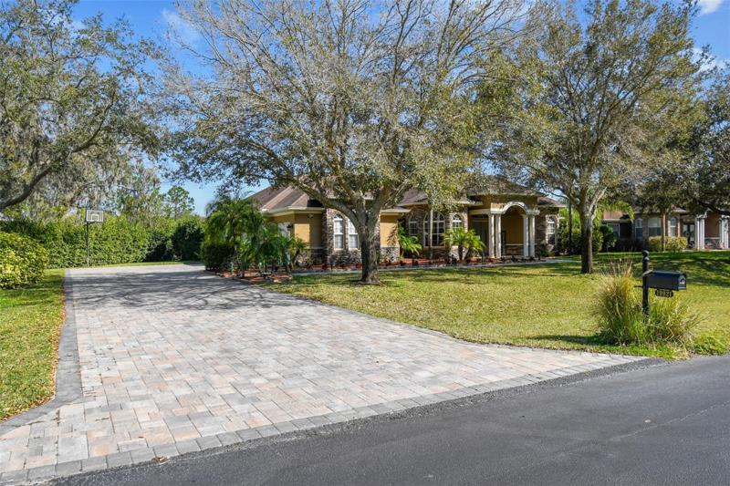 Huge oversized driveway with over 100 feet of pavers making an impressive entrance