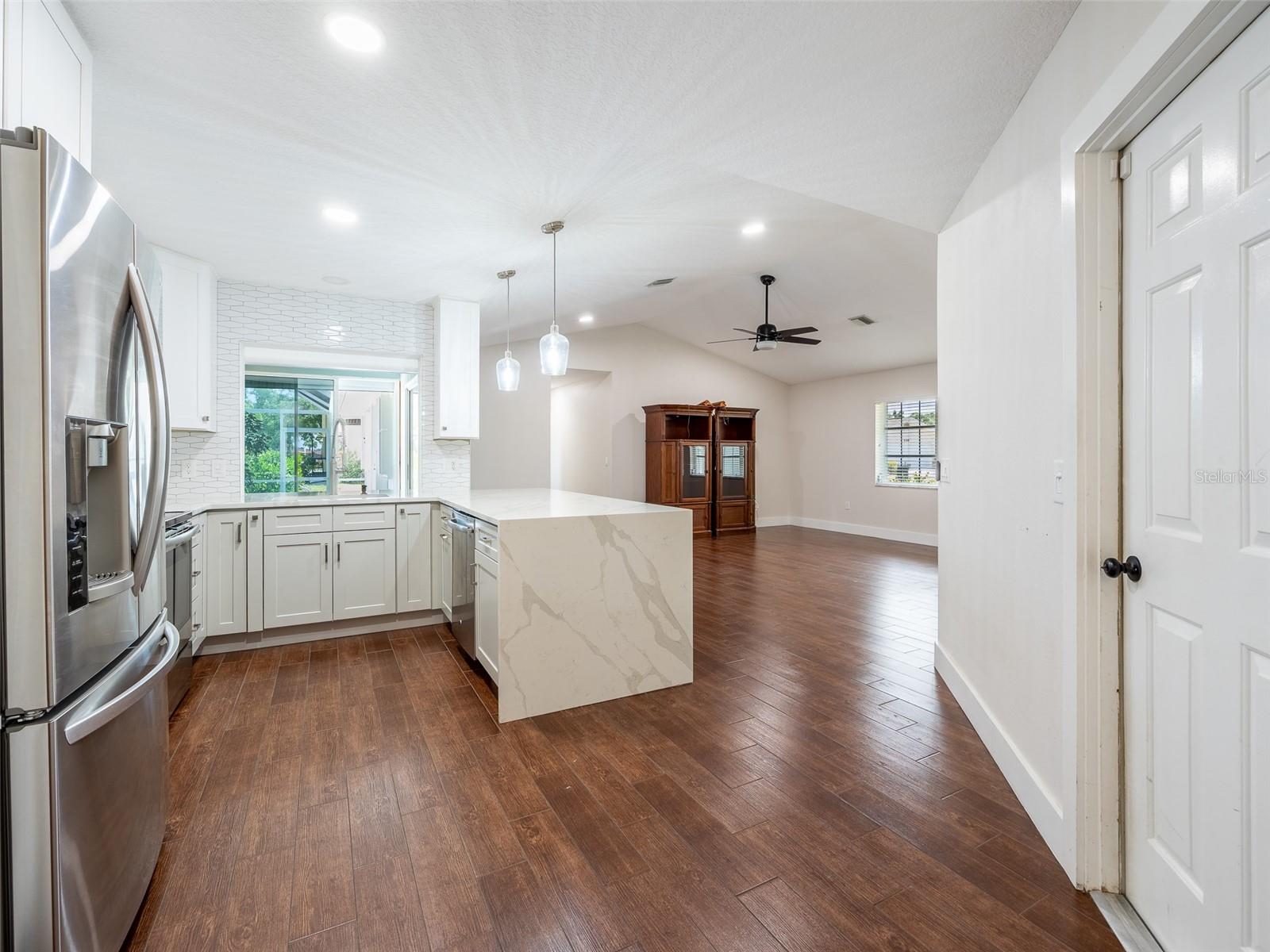 View from Dining Area of Kitchen/Living Combination with the entrance to garage on the right.