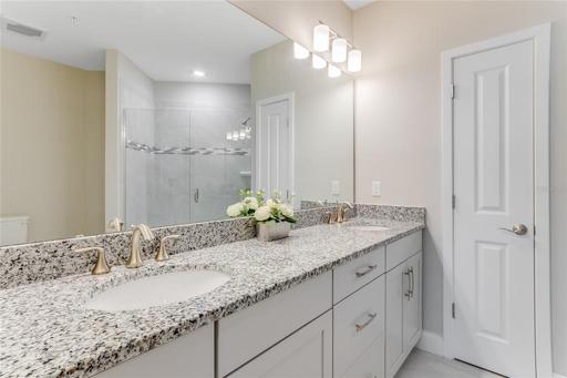 Main Bathroom with double sinks & linen closet