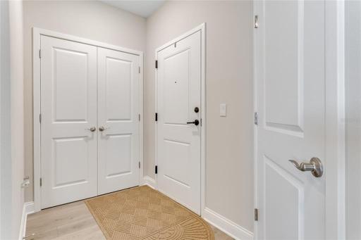 Foyer with additional storage and entrance to laundry room