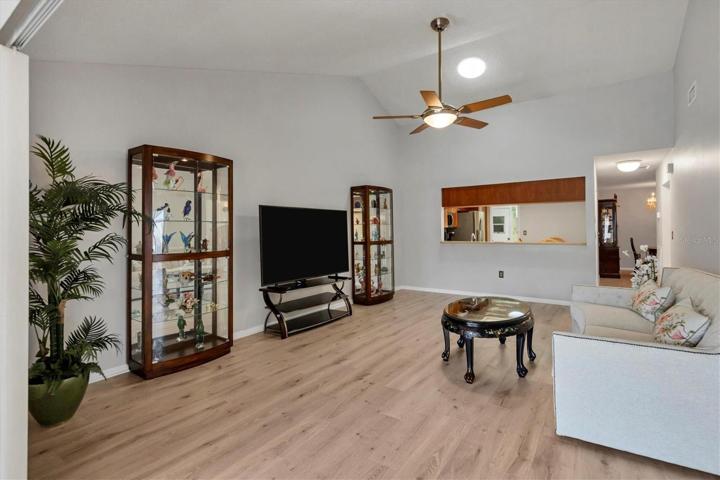 Great room, Vaulted ceiling wood laminate floor, looking back toward the kitchen