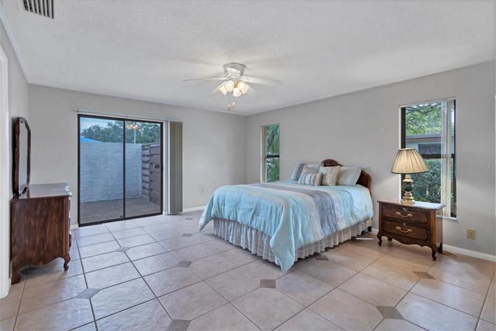 Large Master bedroom tile floor, patio view, walk in closet