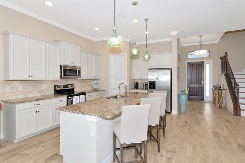 Kitchen with breakfast bar, stainless steel appliances and corner pantry