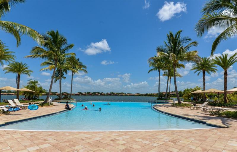Clubhouse pool with beach entrance and infinity edge overlooking lake