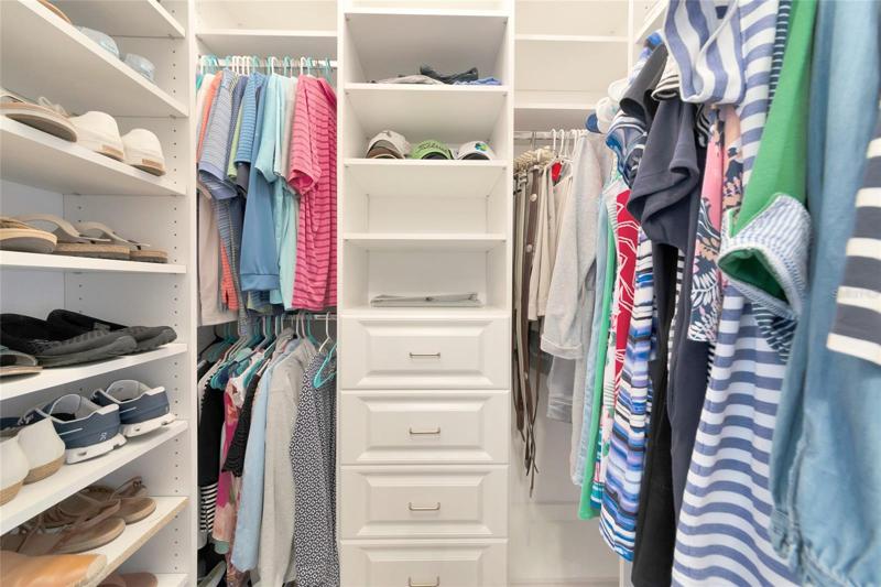 Master bedroom walk in closet with custom built ins