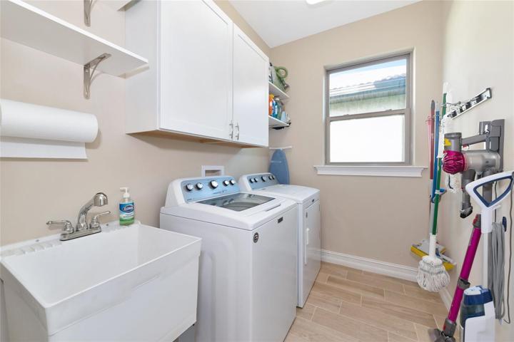 Laundry room with cabinets and shelves