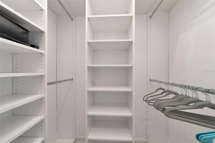 Master bedroom walk in closet with custom built ins