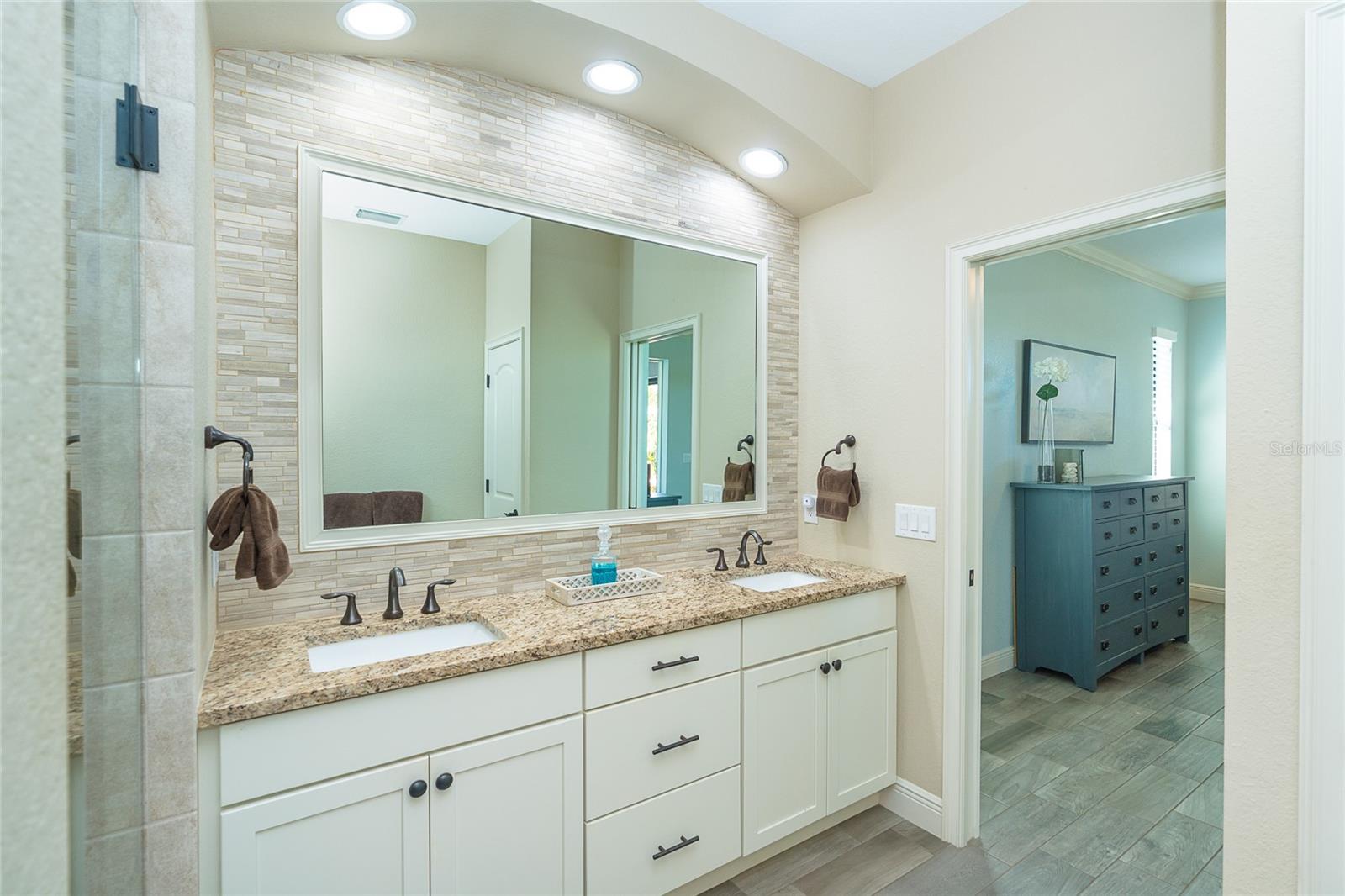 Owners Bath with dual sinks and beautiful backsplash upgrade
