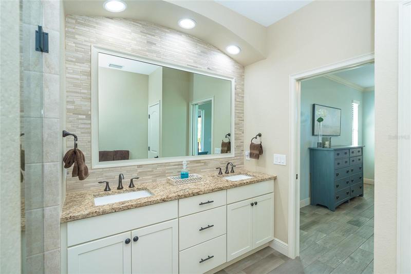 Owners Bath with dual sinks and beautiful backsplash upgrade
