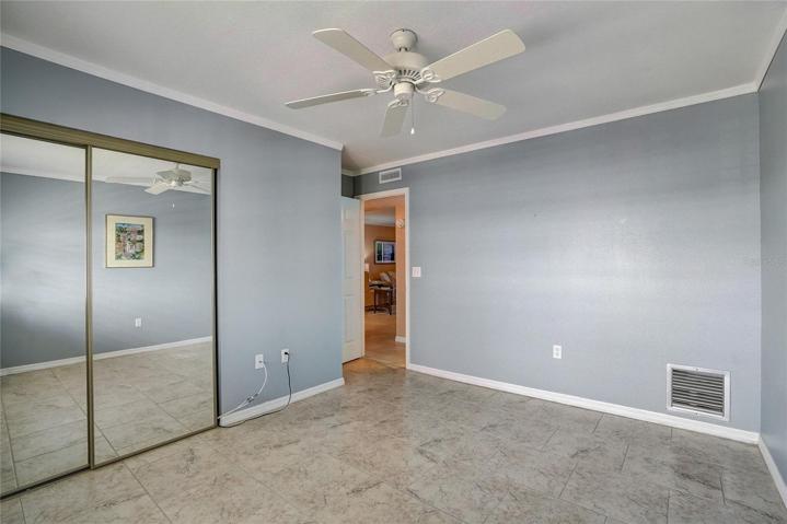 Guest bedroom, window faces east, plantation shutters.