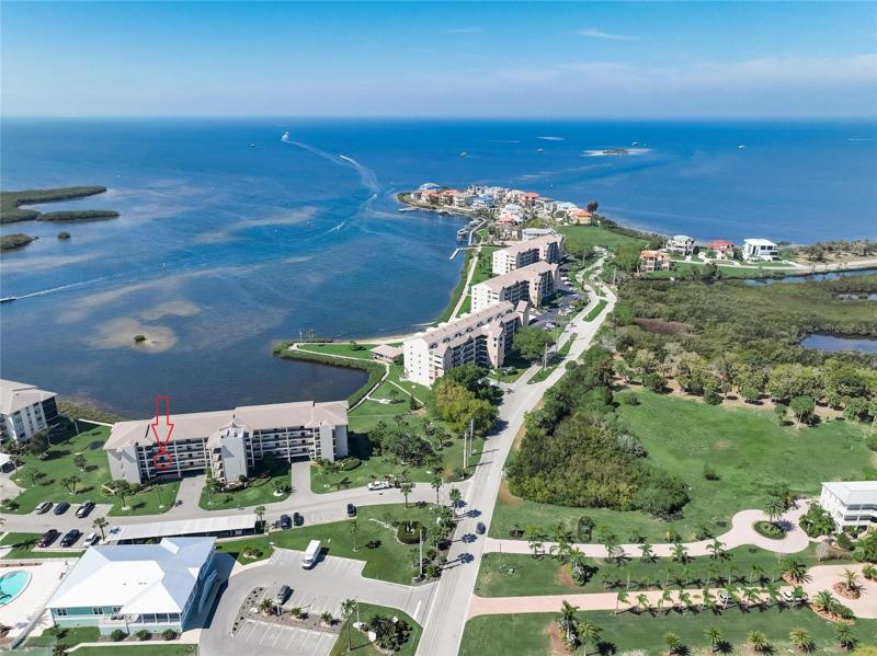 Drone shot of beautiful backdrop, front door of unit is circled in red.