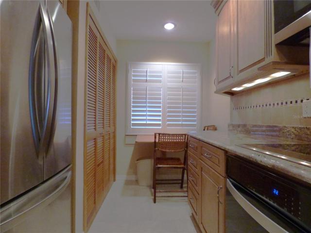 Small drop down table under window. Laundry, water heater and air handler in closet past the refrigerator.