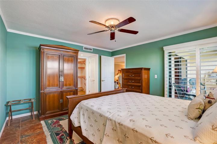 Master bedroom with slider to the lanai and a window to the Gulf! Both have plantation shutters.
