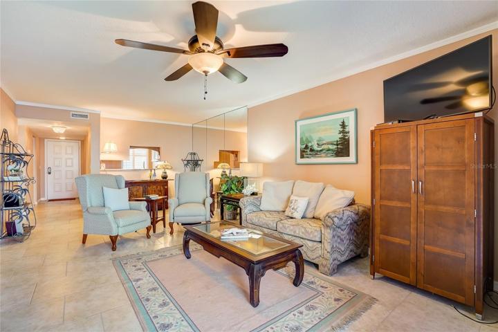 Living room with double sliders that open to the lanai. Tons of light and a view  that seemingly changes all day long! Master bedroom door to right.