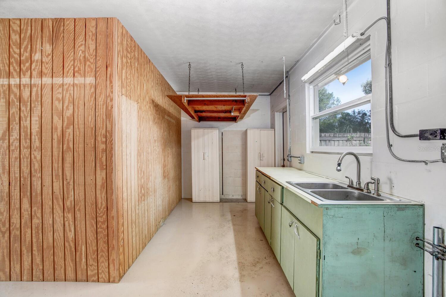 LOTS of storage space and a utility sink with a light over the window.