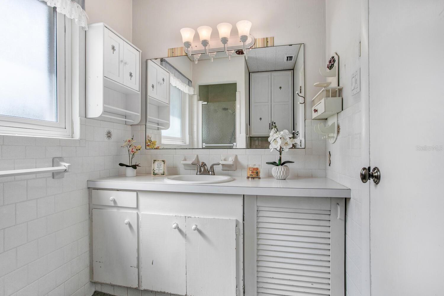 The master bathroom has a walk-in shower and a HEAT LAMP OVERHEAD!