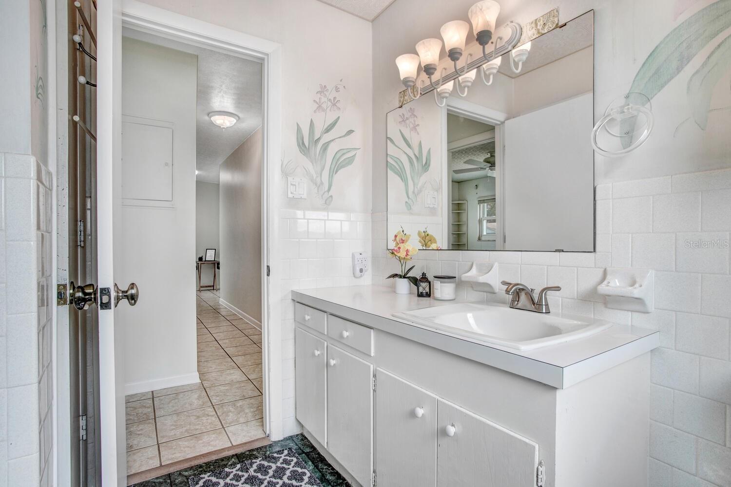 Hall bathroom w/ linen closet behind the door.