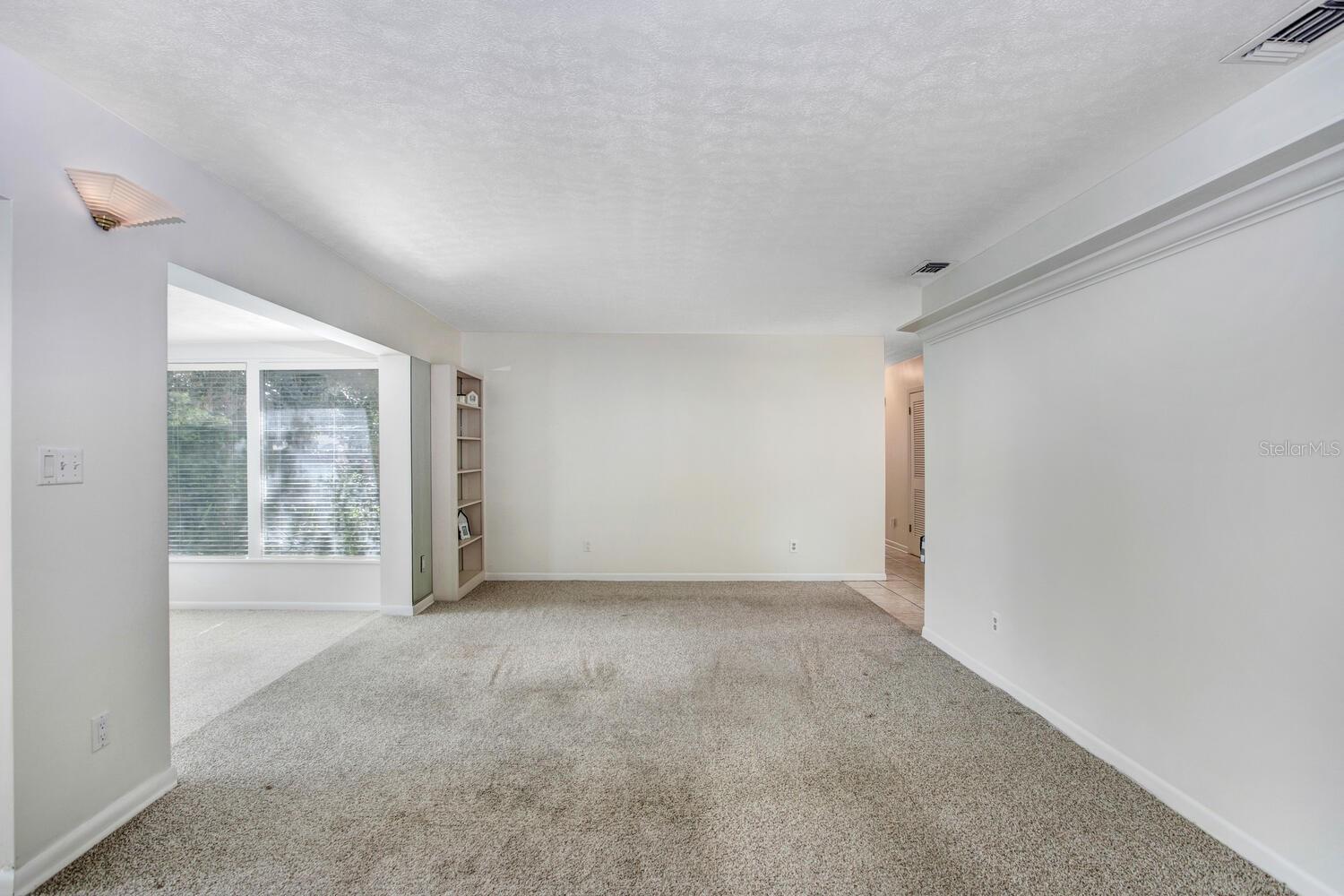 This is the family room!  The carpet is very easily replaceable, and the listing price reflects the flooring needing to be changed.