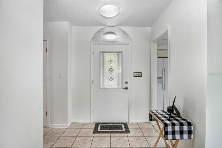 The foyer of the home is very welcoming, and there's a SKY TUBE overhead to allow natural sunlight or moonlight to shine in.